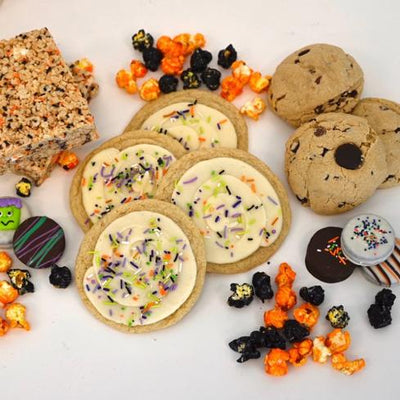 Gluten Free Halloween Treat assortment, sugar cookies, chocolate chip cookies, chocolate covered oreos, Rice Crisp treats, popcorn, all gluten free.
